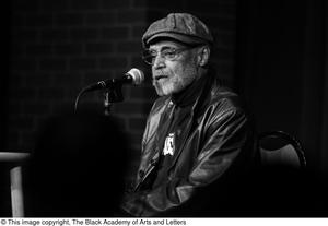 [Photograph of Melvin Van Peebles on a stage at a film festival]