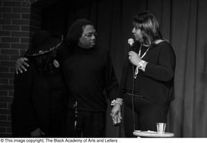 [Photograph of Isabell Cottrell speaking on stage with Curtis King and Barbara Steele]
