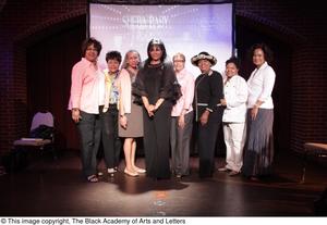 [Pam Grier poses with women on stage]