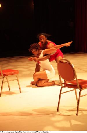 [Photograph of two individuals in leotards performing a dance on stage]