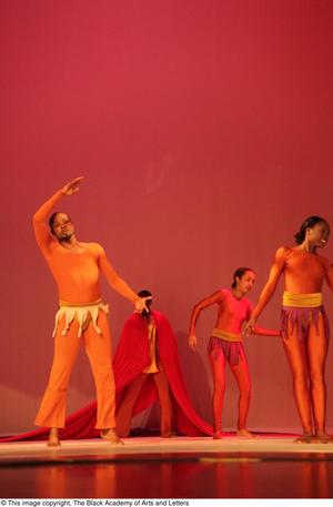 [Photograph of dancers posing in orange leotards]