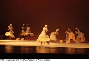 [Photograph of eight women dancing on stage]