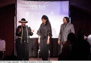 [Pam Grier and Curtis King stand on stage with woman]