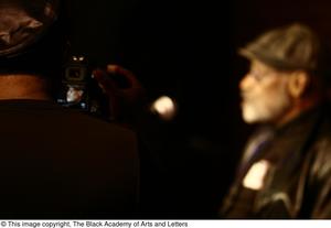 [Photograph of an individual taking a picture of Melvin Van Peebles, 3]