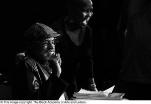 Primary view of object titled '[Photograph of a woman posing with Melvin Van Peebles on stage]'.