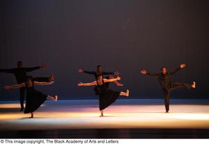 [Photograph of five dancers on stage in black clothing]