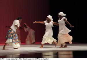 [Photograph of women running towards each other on stage, 2]
