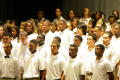 Primary view of [Choir stands on stage in front of audience]