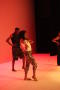 Photograph: [Photograph of dancers on stage in front of a red screen]