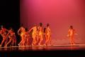 Photograph: [Photograph of a group of dancers standing on a stage in orange leota…