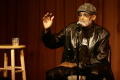 Thumbnail image of item number 1 in: '[Photograph of Melvin Van Peebles giving a talk on stage at a film festival]'.