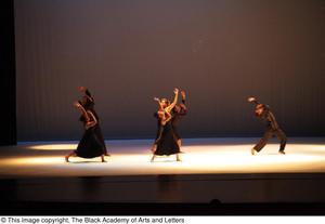 [Photograph of six dancers performing on a stage in black clothing]