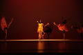 Photograph: [Photograph of six individuals performing a dance on a dark stage]