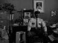 Photograph: [Photograph of Lee Bilal seated in his office]