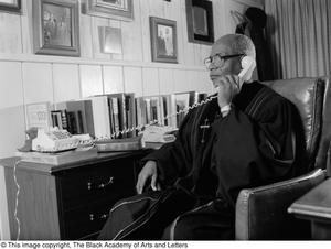 [Photograph of Bishop Calvin Charles Berry on the phone]