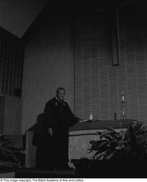 [Photograph of Dr. Marshall E. Hodge standing at church altar #2]