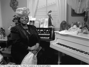 [Francine Morrison seated at her pianos posing for her picture]