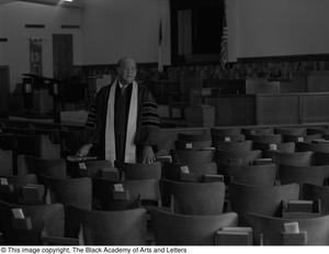 [Reverend J. D. Mooring standing in Church hall]