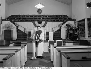 [Photograph of Dr. S. M. Wright standing in a church's nave #2]