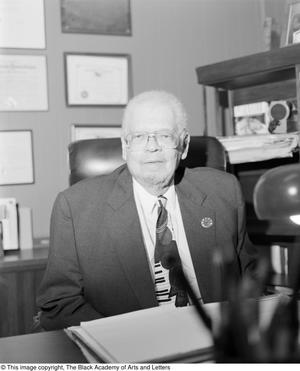 [Photograph of Fred Leonard Lander, III seated at his office desk]