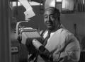 Photograph: [Photograph of Dr. Strotha E. Hardeman, Jr. and his dental equipment …