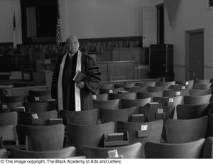 [Reverend J. D. Mooring standing in Church hall, 2]
