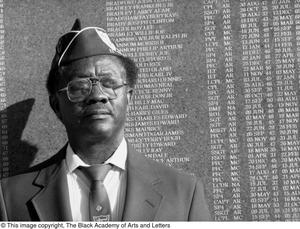 Primary view of object titled '[Photograph of Willie Parker in front of memorial]'.