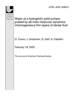 Water at a hydrophilic solid surface probed by ab-initio molecular dynamics: inhomogeneous thin layers of dense fluid