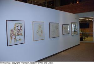 [Photograph of an African gallery wall, featuring five art works]