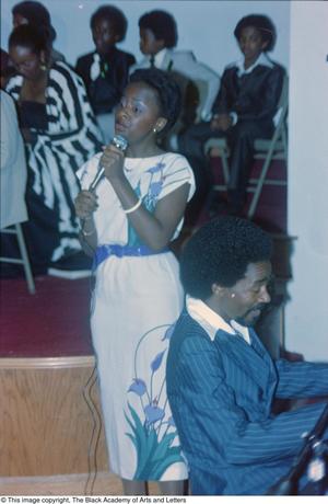 [Photograph of young woman singing at the Black Women in Arts conference]