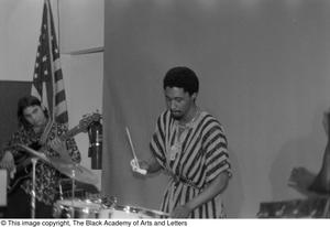 [Photograph of drummer performing with band mates at conference for Black Women in the Arts]