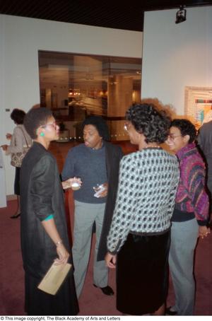 [Photograph of Curtis King and guests at exhibition]