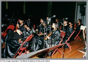 [Photograph of some student performers seated onstage]
