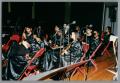 Photograph: [Photograph of some student performers seated onstage]