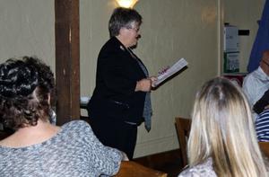 [Woman addresses TXSSAR members and guests during meeting]