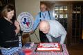 Photograph: [TXSSAR member Dick Lee blowing out candles]