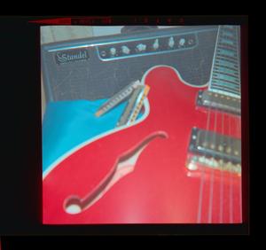 [Photograph of a red guitar]