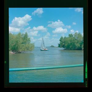 [Photograph of a blue sailboat on the water]