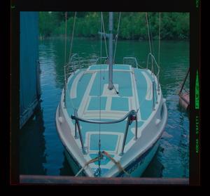 [Photograph of a small sailboat at a dock]