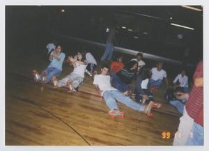 [Photograph of TAMS students sitting at a skating rink]