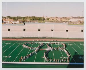 [Photograph of TAMS students in a "98" formation]