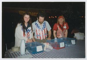 [Photograph of three adults in costumes at a table]