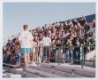 Photograph: [Photograph TAMS students interacting and posing on UNT bleachers]