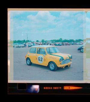 Primary view of object titled '[Photograph of a yellow race car at Green Valley Raceway]'.