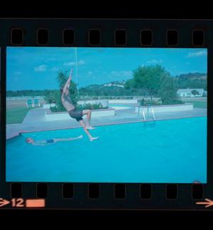[Photograph of boys playing in a pool]
