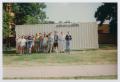 Photograph: [Photograph of TAMS students front of storage container]