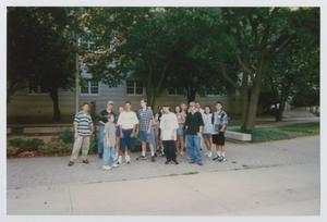 [Photograph of TAMS group posing on sidewalk]