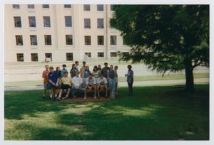 [Photograph of TAMS students posing on memorial bench]