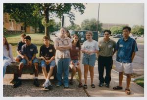[Photograph of TAMS students on a sidewalk and bench]