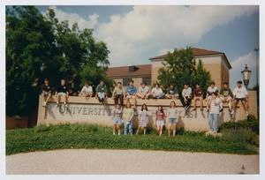 [Photograph of TAMS students posing with UNT sign]